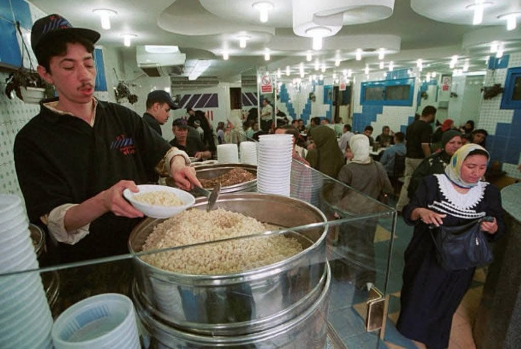 صورة من داخل أحد محلات الكشري في القاهرة عام 2004 تُظهر أجواء المطعم وإقبال الزبائن على الوجبة المصرية الشهيرة.